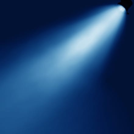 A spotlight against a blue background.