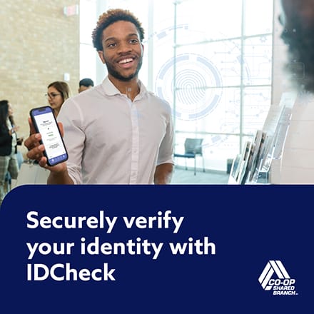 A young man presenting an IDCheck ti a teller.