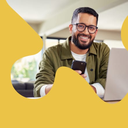 The face of a similing man in a clip mask of a puzzle piece.