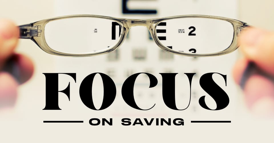 An eyeglass looking at a snellen chart. At the bottom, the words: focus on saving.