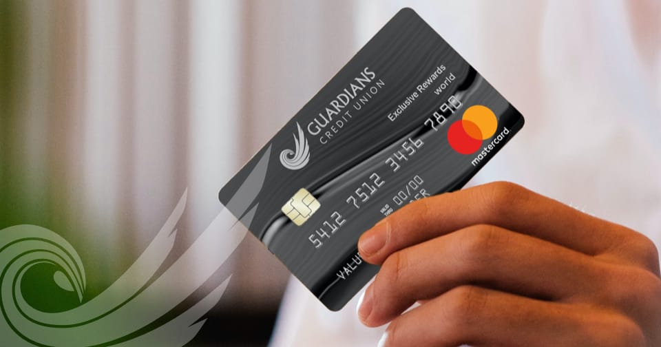 A hand holding the Guardians Credit Union Mastercard.