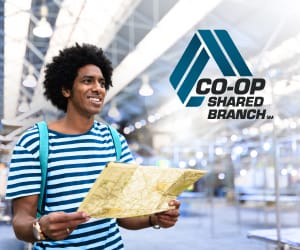 A man wearing a backpack holding a map with the CO-OP Shared Branch logo at the top right