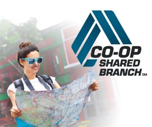 A woman wearing sunglgasses holding a global map with the Co-Op Shared Branch logo at the top right.