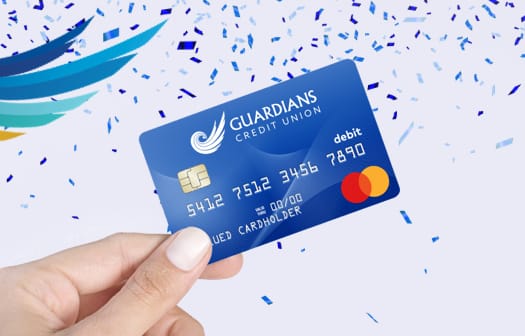 The Guardians Credit Union Debit Card with blue confetti around it.