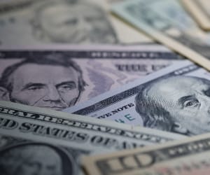 US Dollar bills spread over a table.