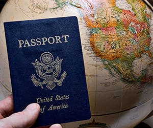 A United States passport held over a globe