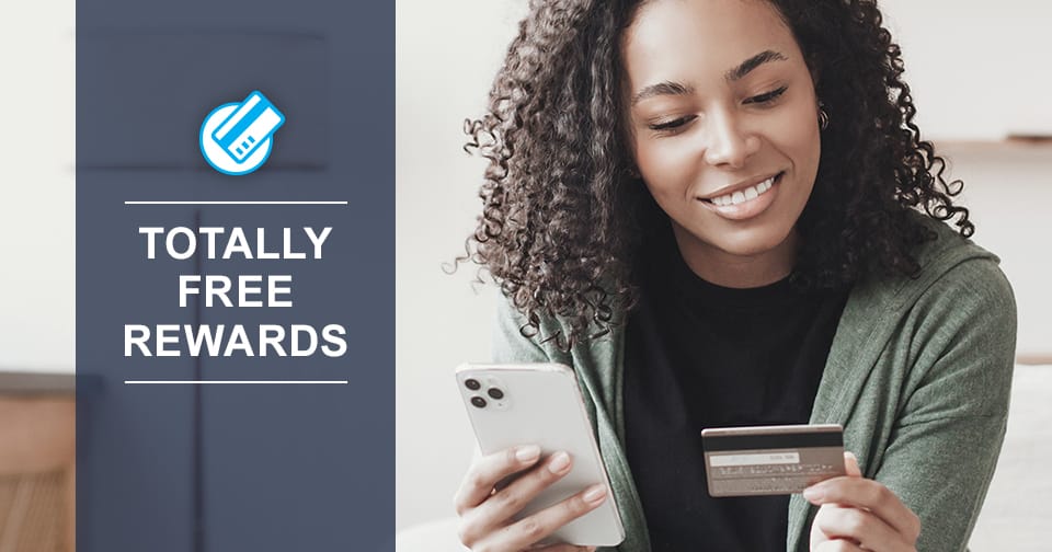 A young woman holding a debit card and a smart phone. At the left, the words: totally free rewards.