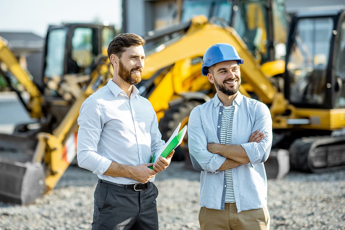 Two men standing in a construction site.