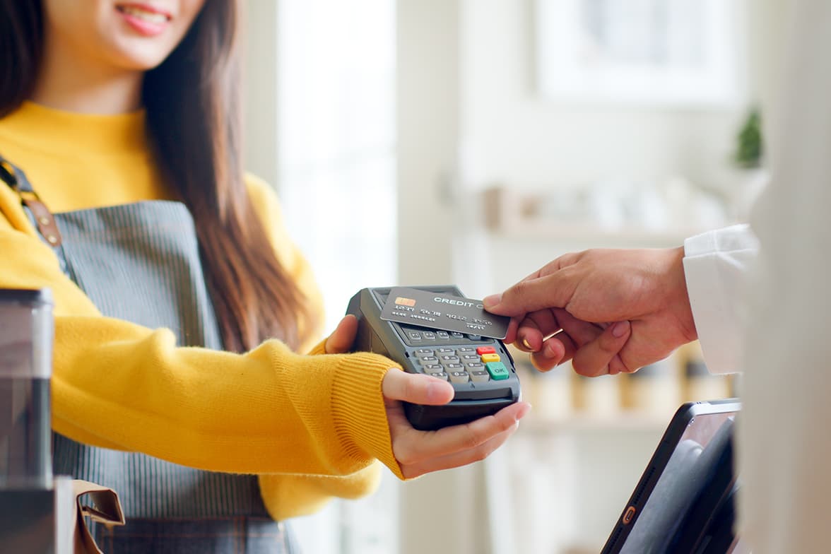 A person conducting a tap-to-pay transaction.