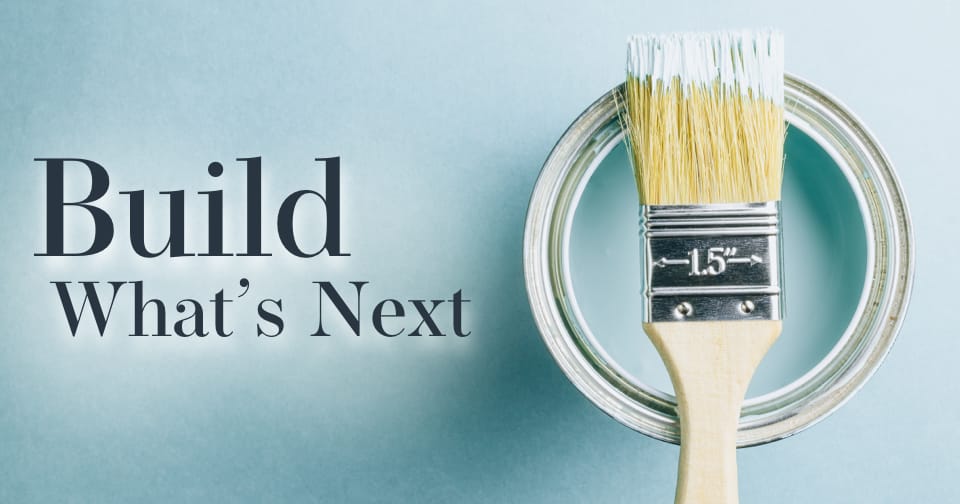 A paint brush resting on top of a paint can. To the left, the words: build what's next.