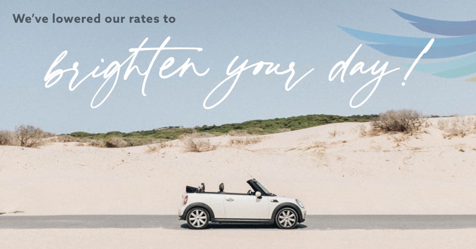 A BMW Mini Cooper parked on the beach. At the top, the words: We've lowered our rates to brighten your day!