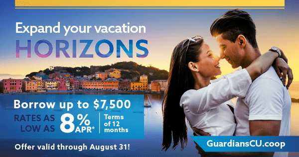 A young couple embracing eachother over a beautiful skyline on an ocean bay.